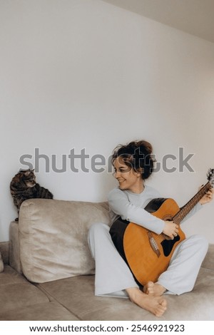 Similar – Image, Stock Photo Calm woman playing guitar in bedroom