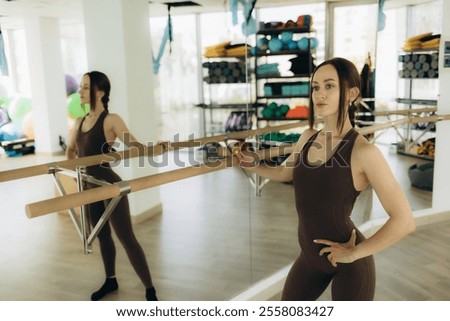 Similar – Image, Stock Photo Slender barefooted woman stretching body in bound angle pose in contemporary studio