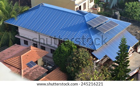 TRIVANDRUM, KERALA, INDIA, JANUARY 17, 2015: Rooftop of houses showing solar panels. Geometric shapes. View from above.