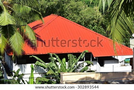 Metallic roof on the terrace of a concrete house to protect it from the elements.