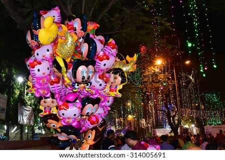 TRIVANDRUM, KERALA, INDIA, AUGUST 29, 2015: Illuminated city roads during Onam celebrations. Scene from Vellayambalam-Museum road at night. Balloon seller at night.