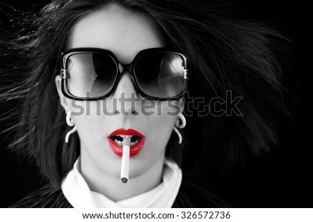 Fashion portrait with red lips, sunglasses, and no-name cigarette