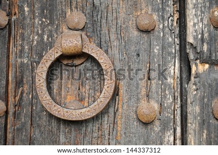 Rusty gate latch on a wooden door