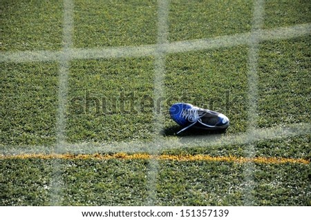 Lonely soccer cleat in front of the goal