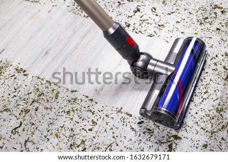 Vacuum cleaner on the floor. House cleaning concept. Before and after cleaning. Dirty and cleaned area. Housekeeping. Modern vacuum cleaner while vacuuming. Cleaning service