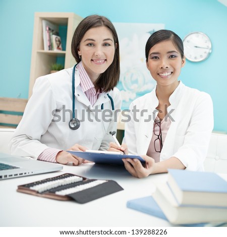 Two female doctors working together.