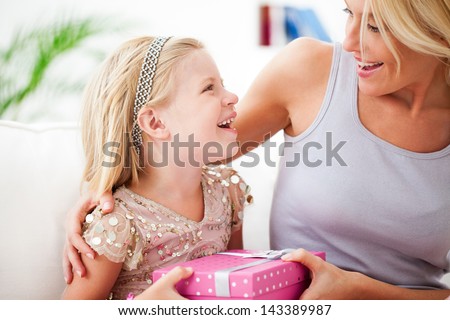 Mother and daughter sharing the happy birthday moments together.