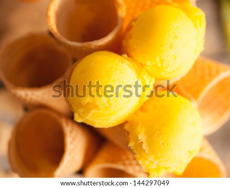 Delicious lemon ice-cream served in ice-cream cones.