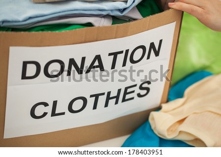 Woman preparing the old clothes she wants to donate for charity.