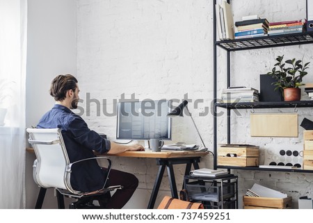 Photo of Young man working on his computer