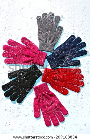 Winter gloves (black, gray, red, pink, blue colors). Studio photography of women\'s gloves - over white background