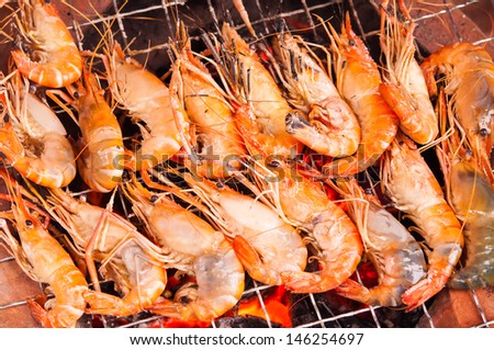 grilled prawns on flaming grill