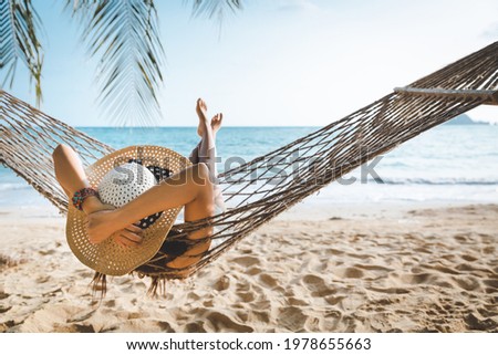 Summer travel vacation concept, Happy traveler asian woman with white bikini relax in hammock on beach in Koh mak, Thailand 商業照片 © 