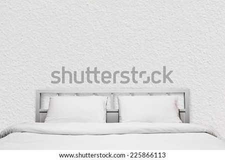 loft interior of white bedroom with white cement wall background