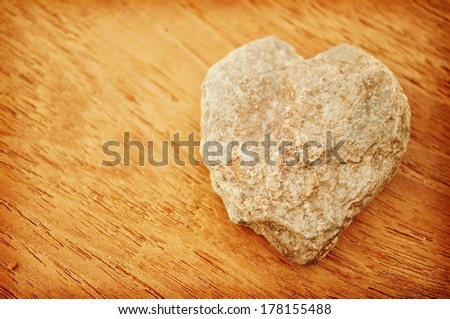 stone in heart shape on the wood background