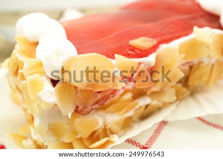strawberries jam cake with almonds slices