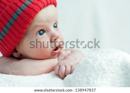 Cute blue-eyed infant with wide eyes in otkoytymi Shake on a white background