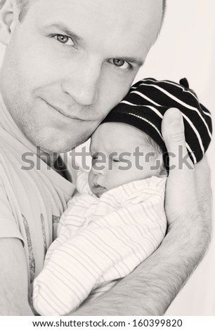 happy father with newborn son on a white background