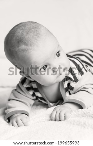 cute blue-eyed baby boy looking to the right on a white background  (black and white)