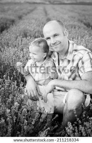 happy dad with baby son in lavender field  ( black and white )