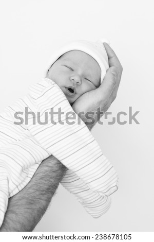 newborn sleeps on a hand on a white background  (black and white)