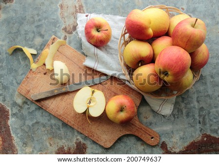 Sweet apples in a wicker. Sliced apple on a cutting board.