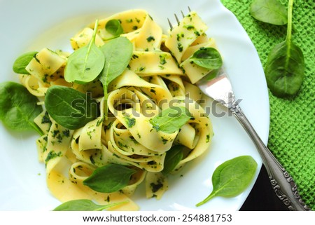 Similar – Image, Stock Photo Green tagliatelle pasta with ham, parmesan cheese, arugula and tomatoes on black plate