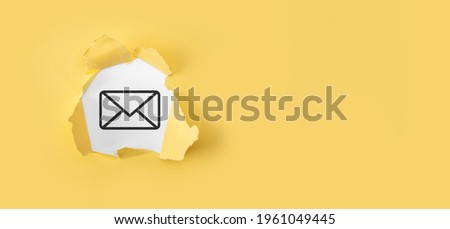 Torn yellow paper with letter email icon on white background.Email marketing and newsletter concept. Contact us by newsletter email and protect your personal information from spam mail concept.