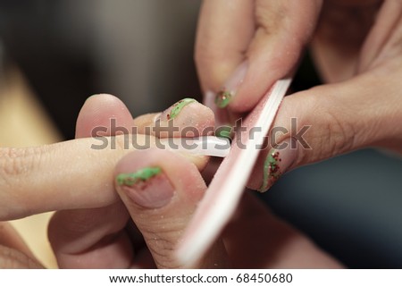 Filing fresh nails in studio