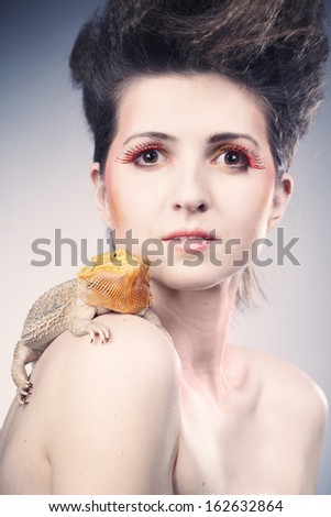 Pretty lady posing with her agama lizard