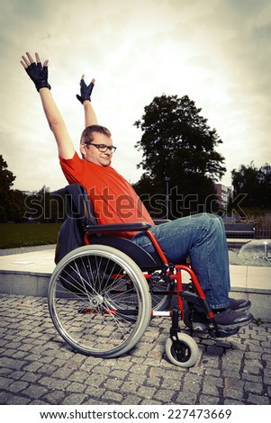 Young man on wheel chair - no obstacles in life