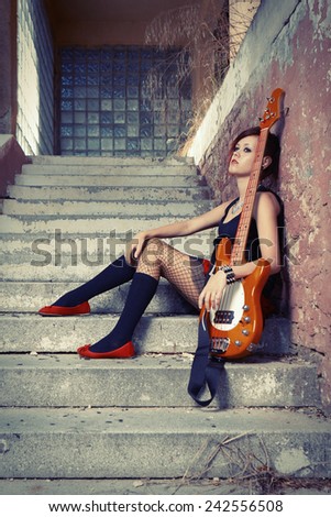 Nice punk/rock player posing on street city location for stylish musician portraits