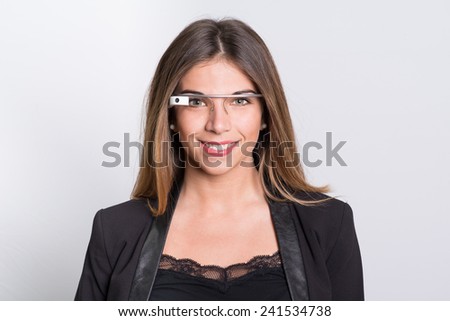 Bologna, ITALY - Jan 5, 2015: A woman wearing Google Glass. Google Glass is a wearable computer with an optical head-mounted display that is being developed by Google