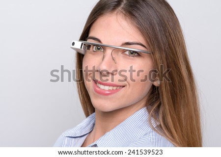 Bologna, ITALY - Jan 4, 2015: A woman wearing Google Glass. Google Glass is a wearable computer with an optical head-mounted display that is being developed by Google
