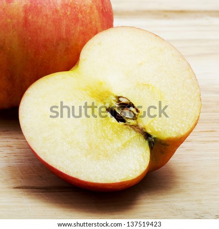 one ripe red apples and half of apple
