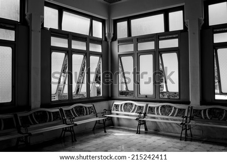 Interior of a hospitall waiting room with a view on windows. Day time, city life.