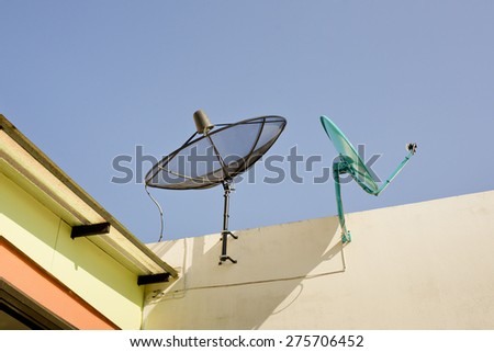 Black and Green Satellite dishs on the roof. Two Satellite dishs on the roof