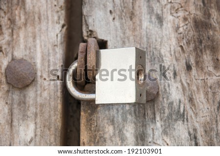 padlock closing an old door