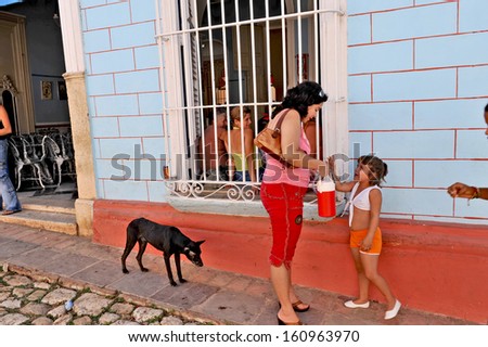 TRINIDAD, CUBA, OCTOBER 27, 2009. A woman, child and a dog in the street in Trinidad, Cuba, on October 27th, 2009.