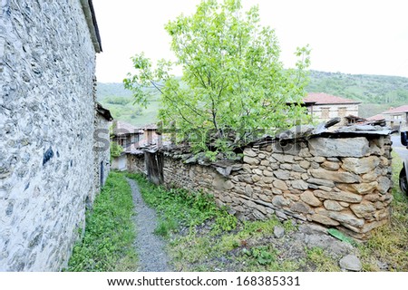 BRAJCINO, MACEDONIA, MAY 18, 2011. A narrow foot path going in between old houses in the first eco village in Macedonia, in Brajcino, Macedonia, on May 18th, 2011.