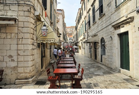 DUBROVNIK, CROATIA, MAY 22, 2011. A narrow street with restaurant tables in the old town of Dubrovnik. in Dubrovnik, Croatia, on May 22nd, 2011.