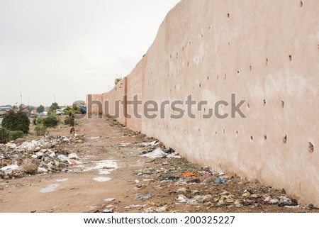 MARRAKECH, MOROCCO, MAY 11, 2014. Part of the barricade wall surrounding the city, with rubbish on the ground, in Marrakech, Morocco, on May 11th, 2014.