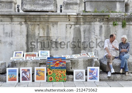 SPLIT, CROATIA, MAY 26, 2011. A man and a woman selling paintings in the streets of the old town in Split, Croatia, on May 26th, 2011.