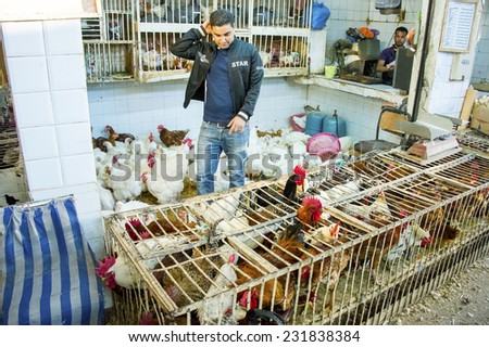 AGADIR, MOROCCO, FEBRUARY 27, 2014. A Moroccan man selling chicken in cages in Souk El Had, the biggest bazar in Agadir, Morocco, on February 27th, 2014.