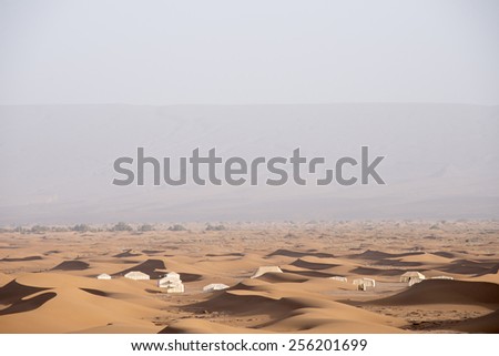 A desert camp in the Sahara desert in Erg Chegaga in Morocco in the spring during a hot sunny day.