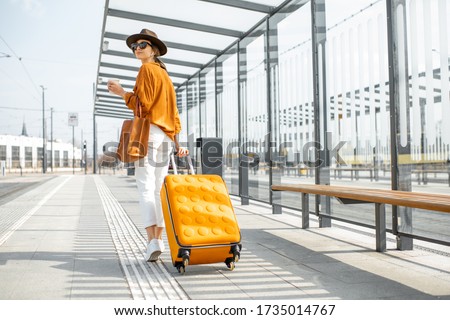 Similar – Image, Stock Photo Young casual female traveler at airport, holding smart phone device, looking through the airport gate windows at planes on airport runway.