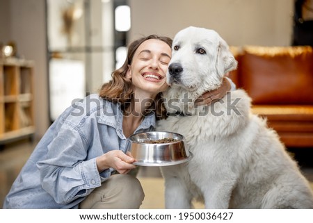 Similar – Image, Stock Photo Woman feeding dog in mountains