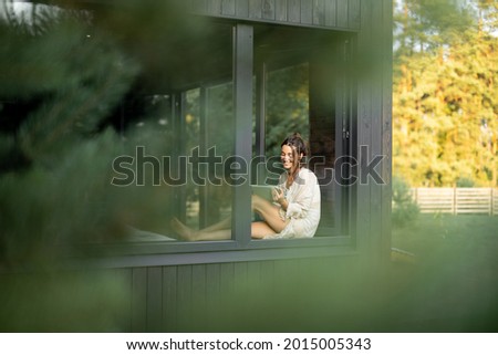 Similar – Image, Stock Photo Woman at home relaxing on sofa couch using social media on phone for video chatting with her loved ones during corona virus pandemic. Stay at home, social distancing lifestyle.