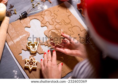 Making ginger cookie on Christmas decorated table