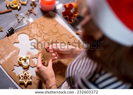 Making ginger cookie on Christmas decorated table